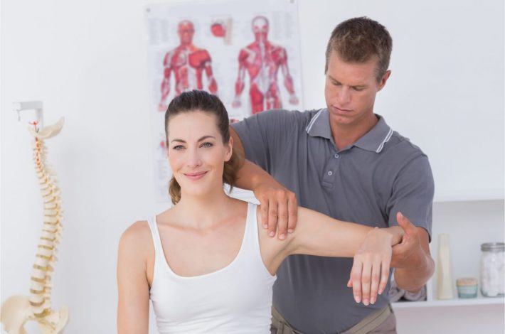 male examining womans muscle